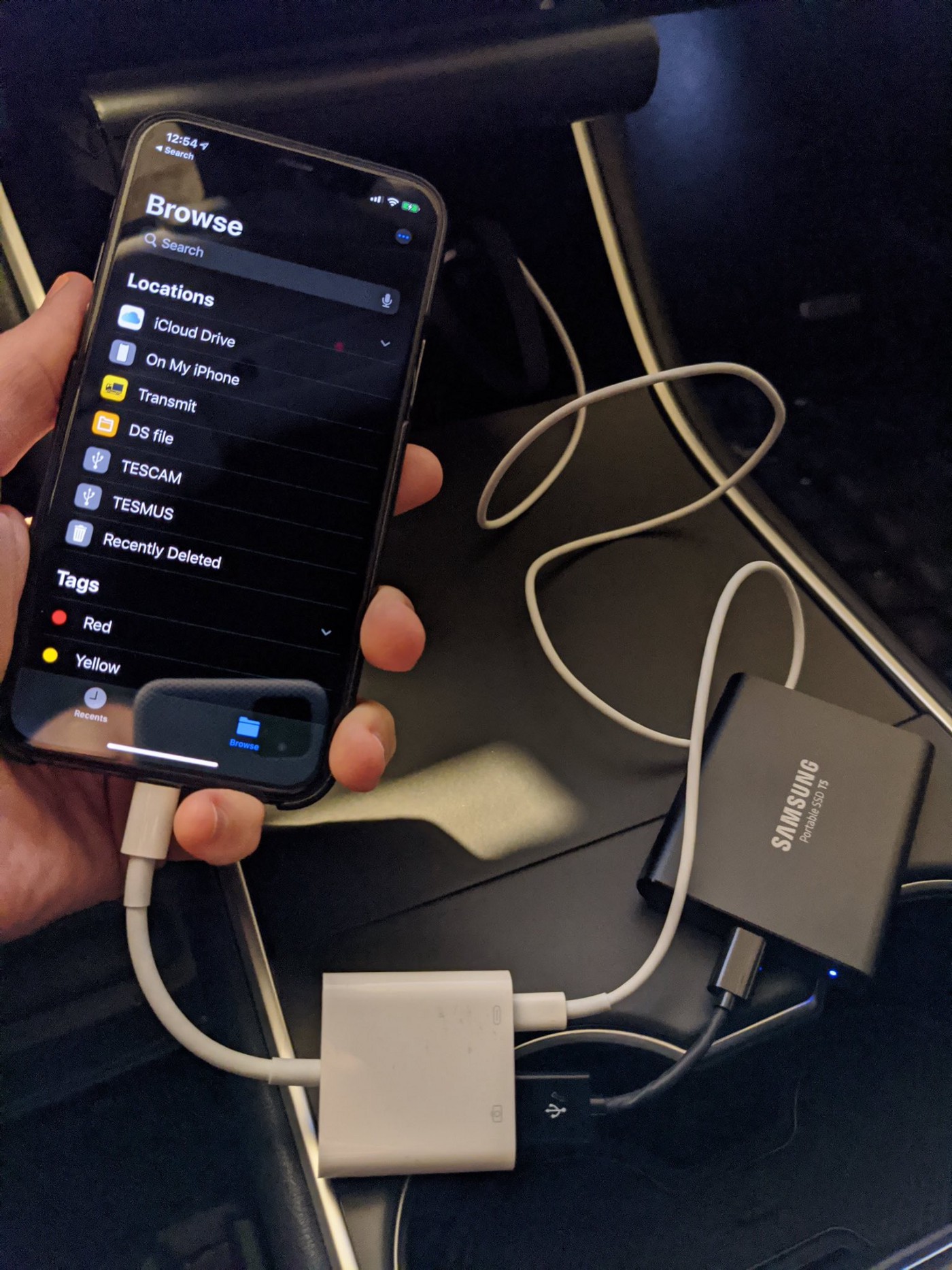 USB, Lightning, and Apple camera adapters connected to an iPhone for viewing Sentry videos